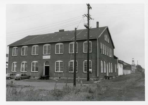 Original Building. The 1888 main building fronting East First Avenue, with the stair tower visible down the length of the site.