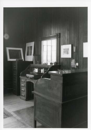 The factory office. Wood paneling, roll-top desk, and counter, cited in the National Register nomination alongside the original time clock and safe.