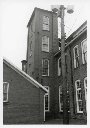 Stair tower. Four levels under a hip roof, added in the 1900 expansion and still the building's signature from the street.